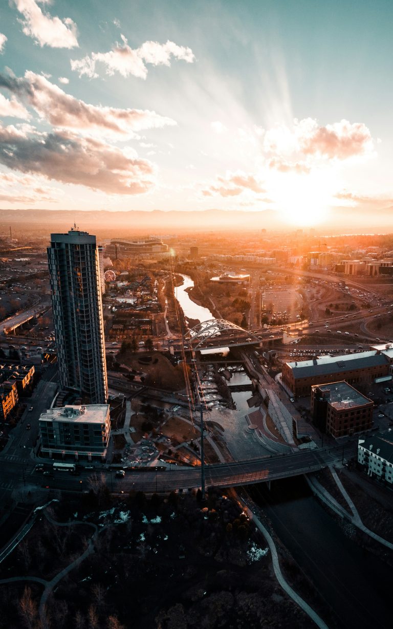 An aerial view of Denver and the South Platte River at sunset.